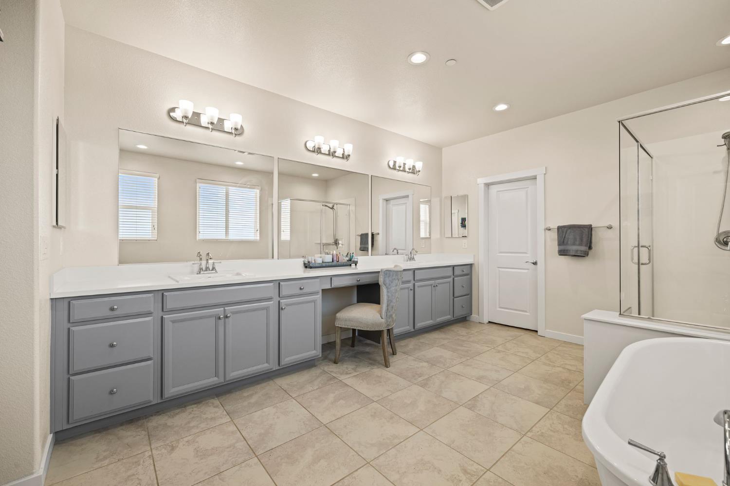 4040 Aura Way Rancho Cordova, CA 95742 - Photo 3 of 49 a large bathroom with a double vanity sink a toilet a mirror and shower