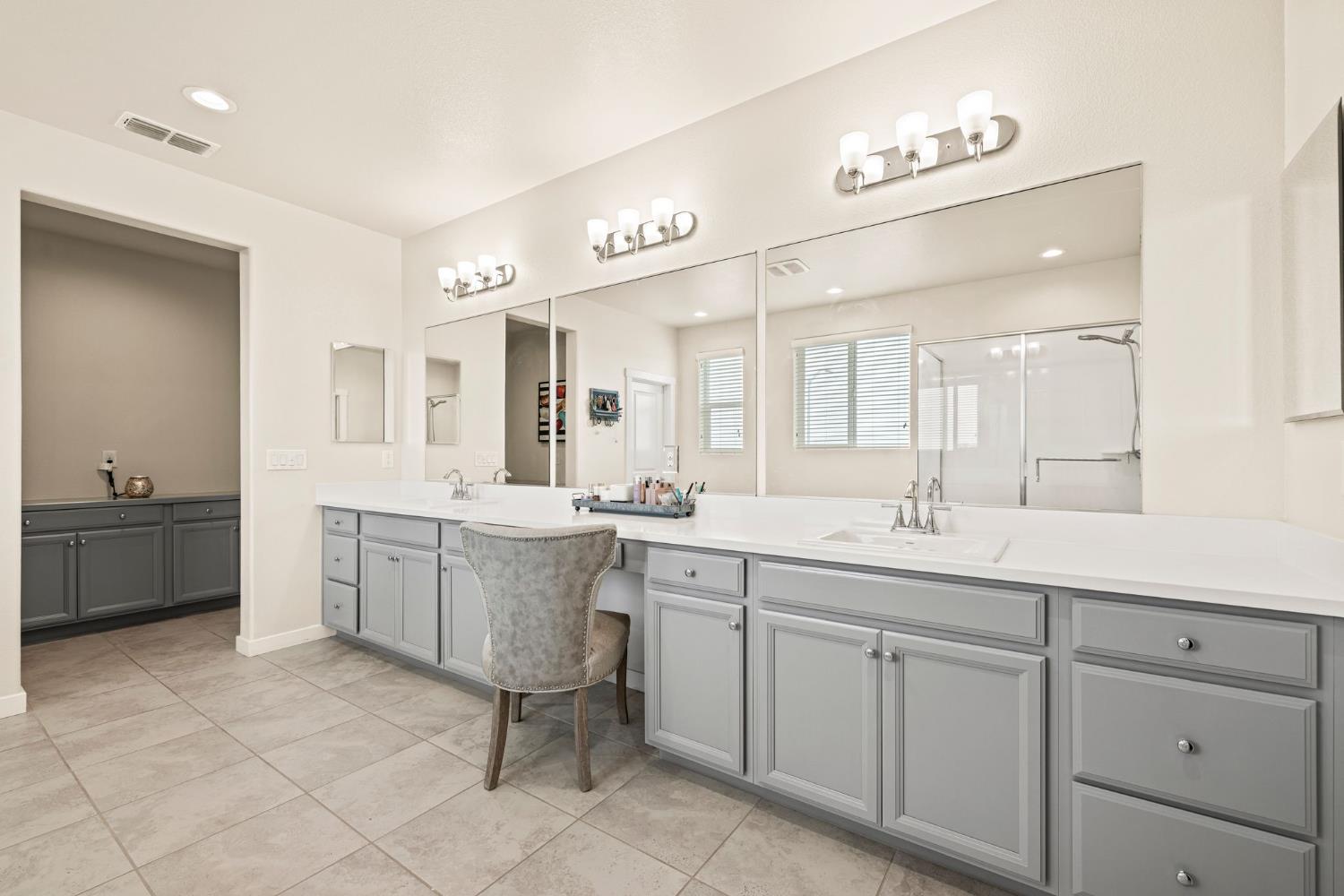 4040 Aura Way Rancho Cordova, CA 95742 - Photo 31 of 49 a spacious bathroom with a granite countertop sink mirror and a