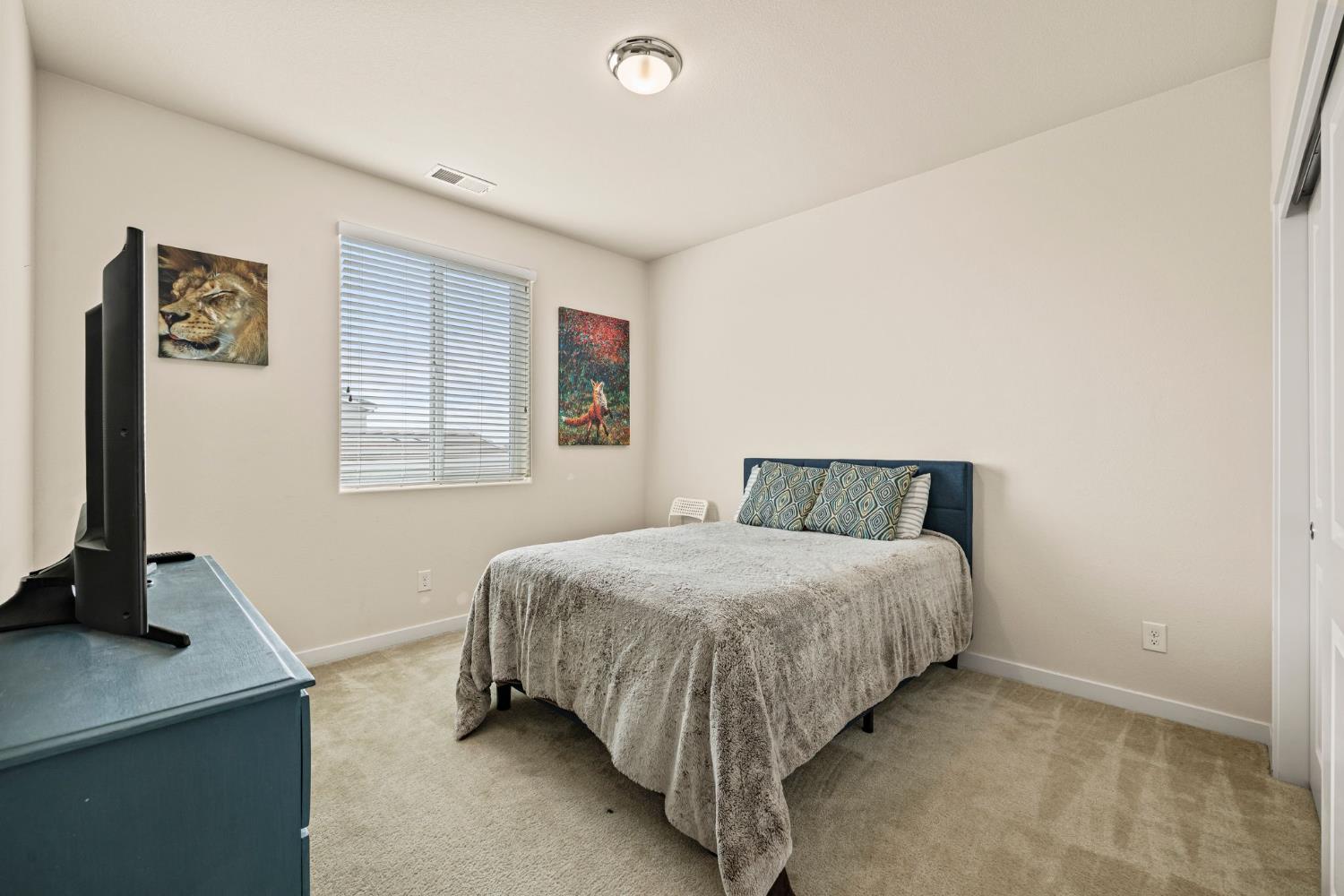 4040 Aura Way Rancho Cordova, CA 95742 - Photo 35 of 49 a bedroom with a bed and a desk