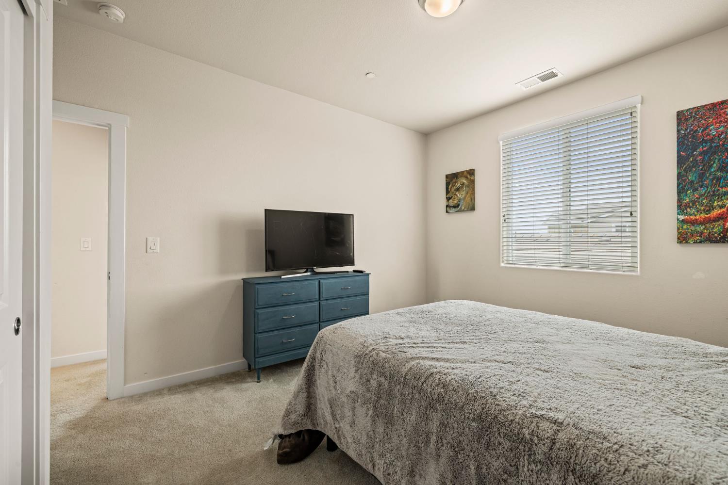 4040 Aura Way Rancho Cordova, CA 95742 - Photo 36 of 49 a bedroom with a bed and a flat screen tv