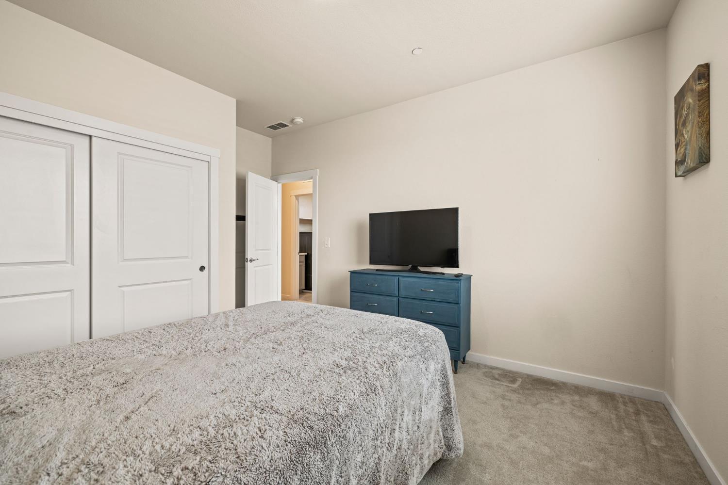 4040 Aura Way Rancho Cordova, CA 95742 - Photo 37 of 49 a bedroom with a bed and a flat screen tv