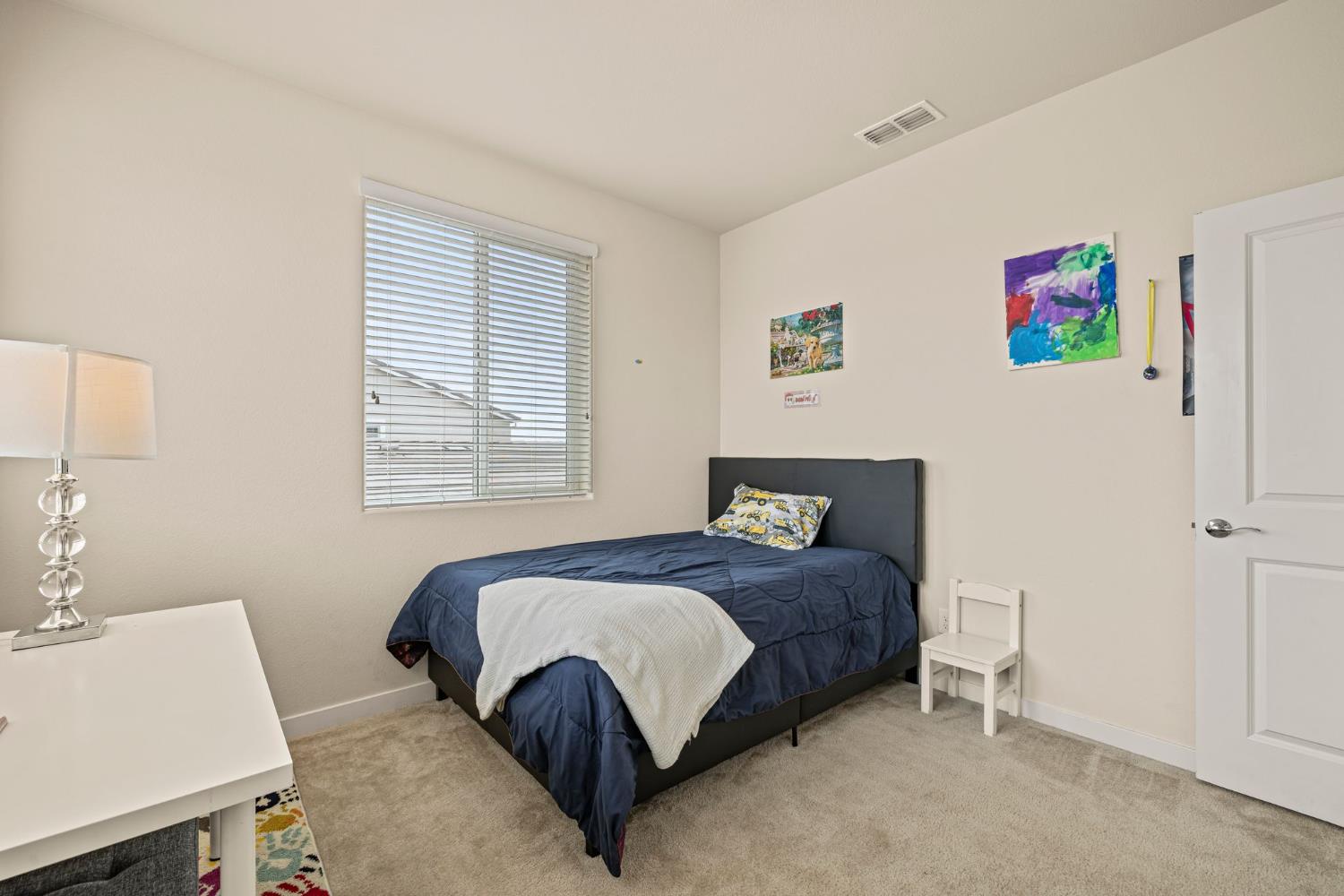 4040 Aura Way Rancho Cordova, CA 95742 - Photo 39 of 49 a bedroom with a bed and a table in it