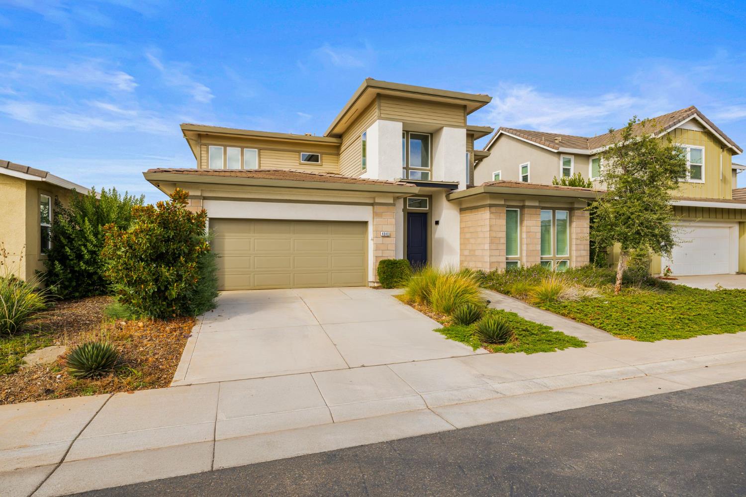 4040 Aura Way Rancho Cordova, CA 95742 - Photo 5 of 49 a front view of a house with a yard and garage