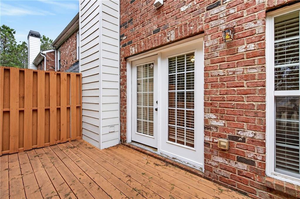 1186 Lake Point Way Suwanee, GA 30024 - Photo 32 of 35 a view of a house with a door and wooden floor