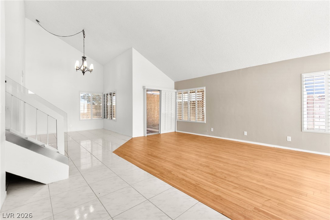 4430 Cranbrook Way Las Vegas, NV 89103 - Photo 9 of 50 A striking contrast of tile and wood flooring defines this versatile living space with elevated ceilings.