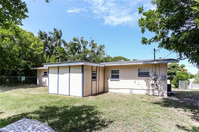 a view of a backyard with a large tree