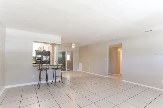 a dining room with furniture and a chandelier