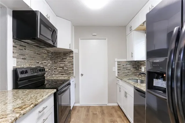 a kitchen with a stove and a refrigerator
