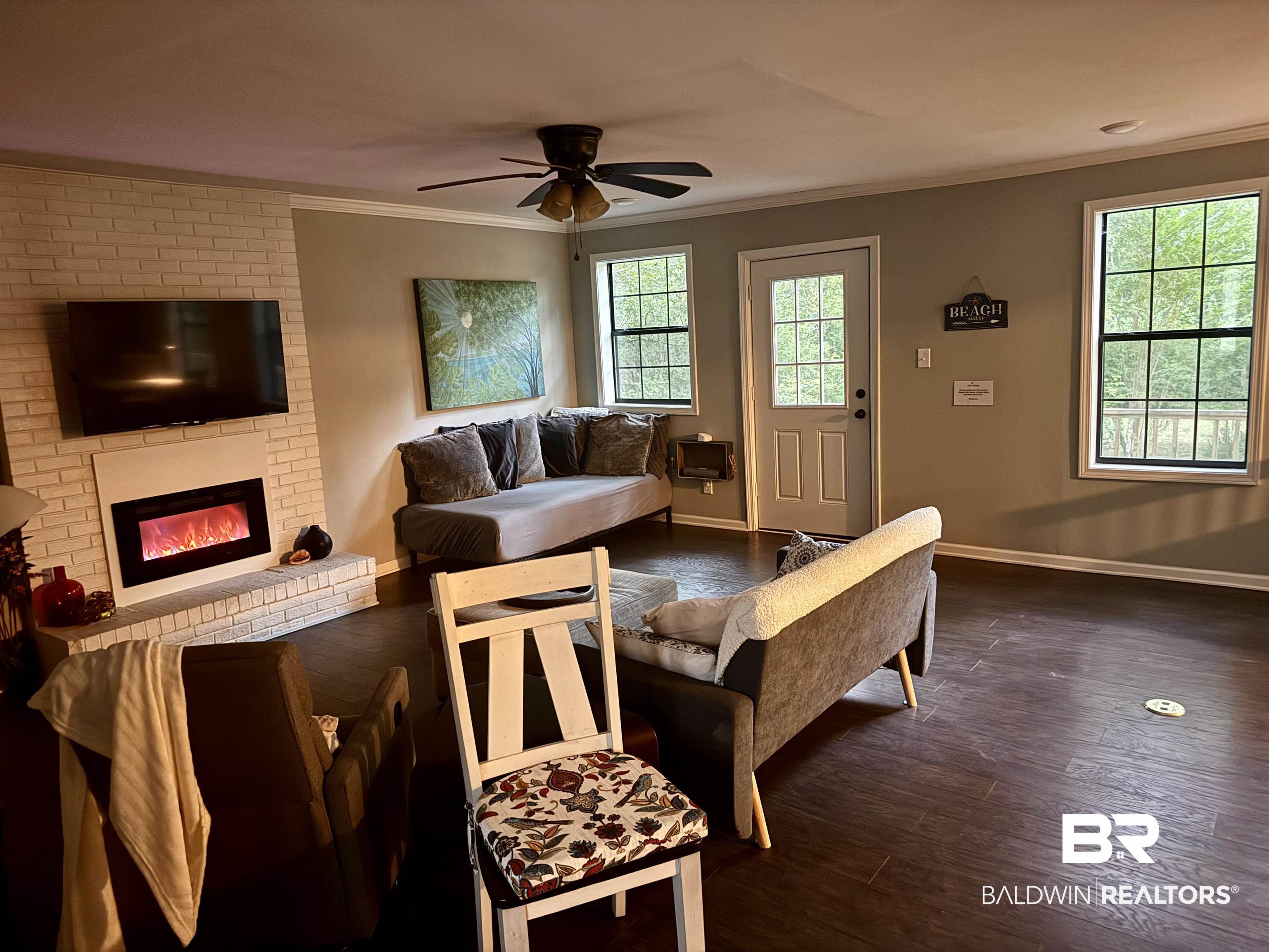 1302 Oak Street Daphne, AL 36526 - Photo 6 of 34 Living room with dark wood finished floors, ceiling fan, a fireplace, and ornamental molding