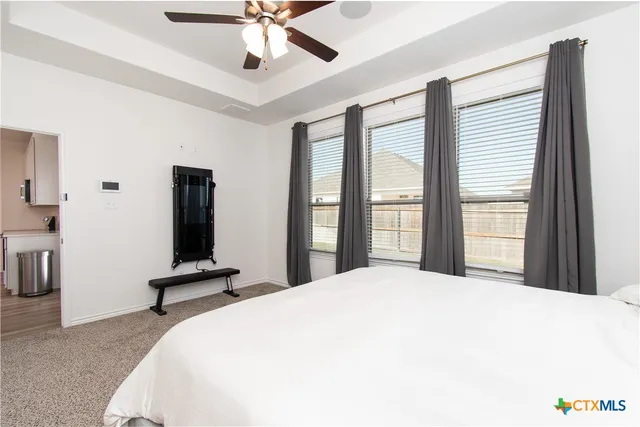 a bedroom with a bed and a large window