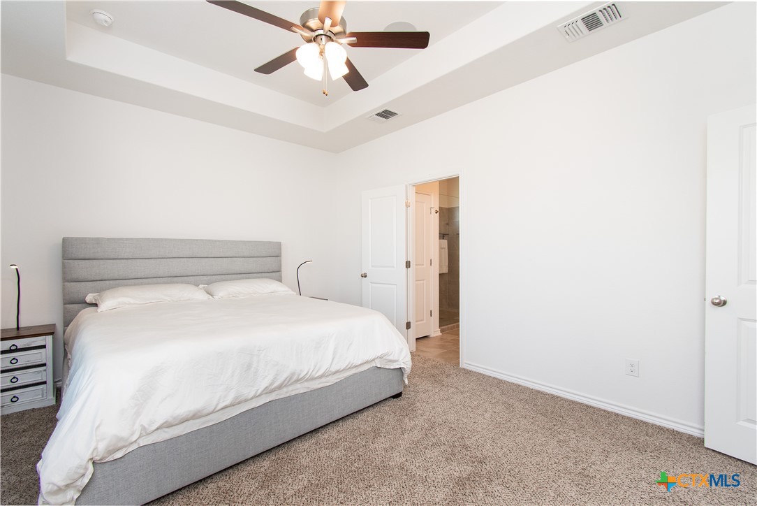 1224 Bending Branch Way Temple, TX 76502 - Photo 12 of 25 a bedroom with a bed and a chandelier