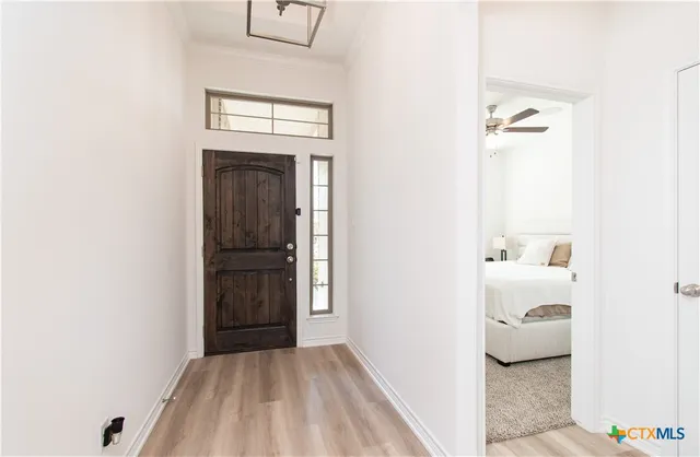 a view of hallway with wooden floor