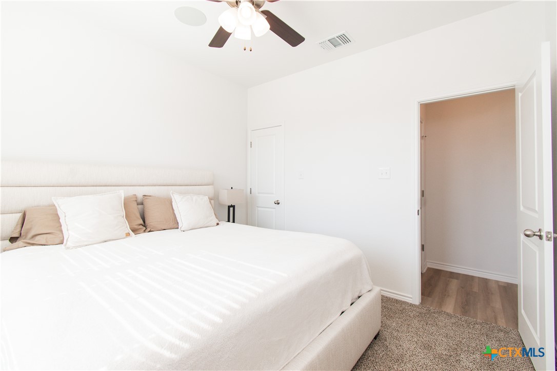 1224 Bending Branch Way Temple, TX 76502 - Photo 22 of 25 a bedroom with a bed and a lamp