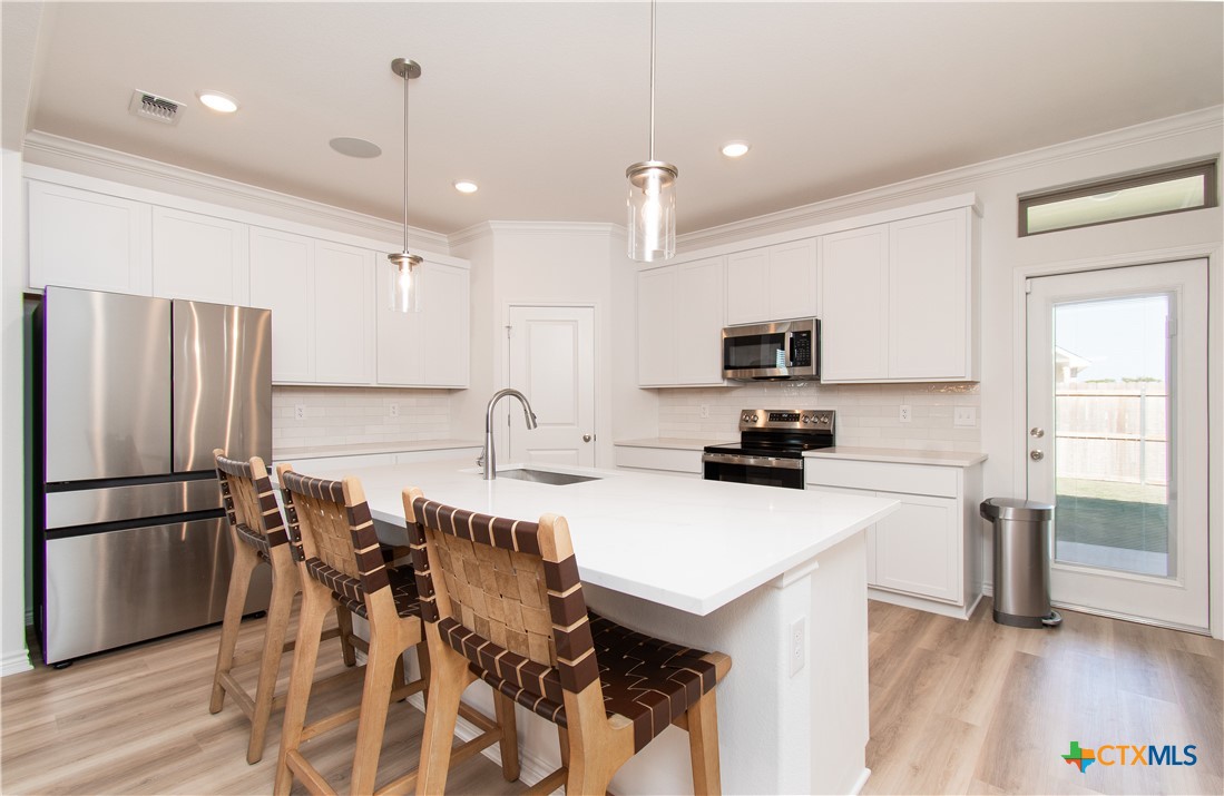 1224 Bending Branch Way Temple, TX 76502 - Photo 7 of 25 a kitchen with a sink a counter top space stainless steel appliances and cabinets