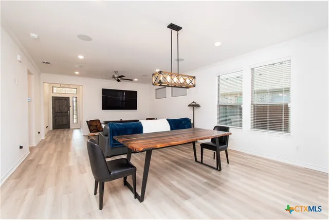 a view of a dining room with furniture window and wooden floor