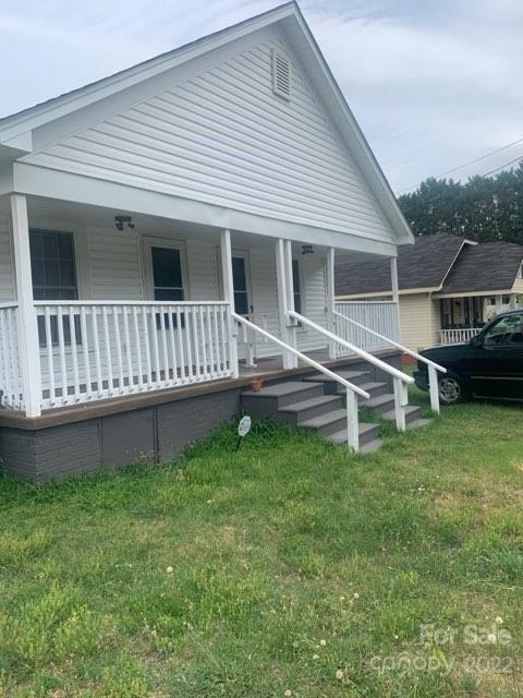 907 Indiana Street Kannapolis, NC 28083 - Photo 3 of 10 a view of a house with a backyard and a wooden deck