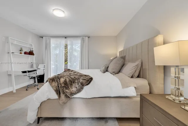 a bedroom with a bed and a lamp on table