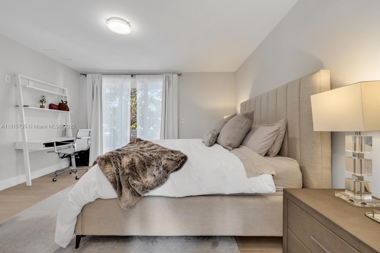 2851 Southwest 33rd Court, Unit 2851 Miami, FL 33133 - Photo 14 of 45 a bedroom with a bed and a lamp on table