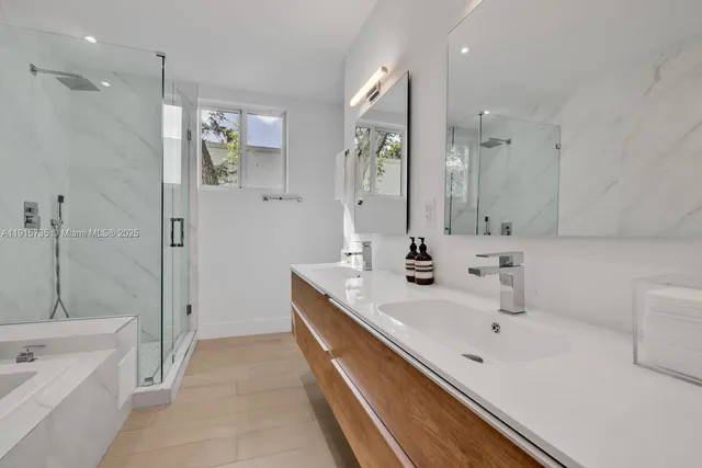 a bathroom with a tub sink and mirror
