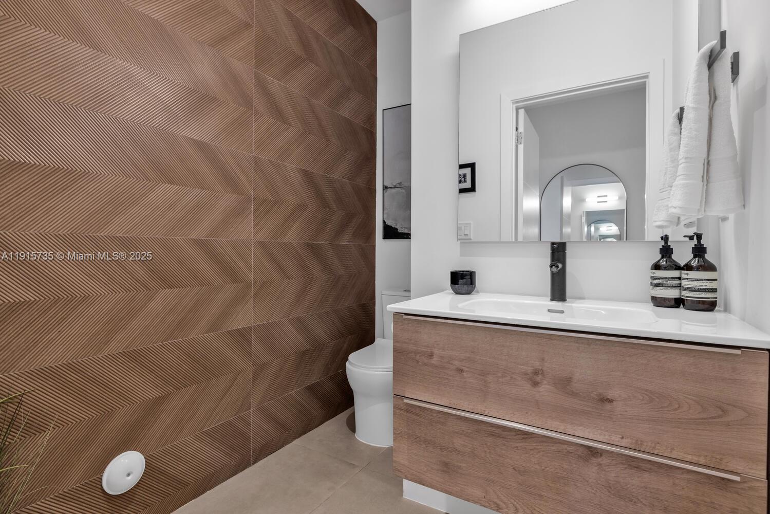 2851 Southwest 33rd Court, Unit 2851 Miami, FL 33133 - Photo 20 of 45 a bathroom with a sink and a mirror