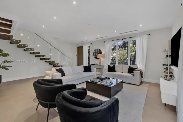 a living room with furniture and flat screen tv