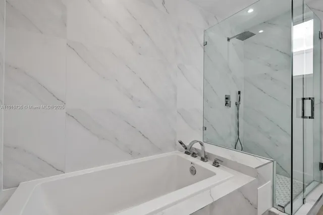 a bathroom with a tub and a shower