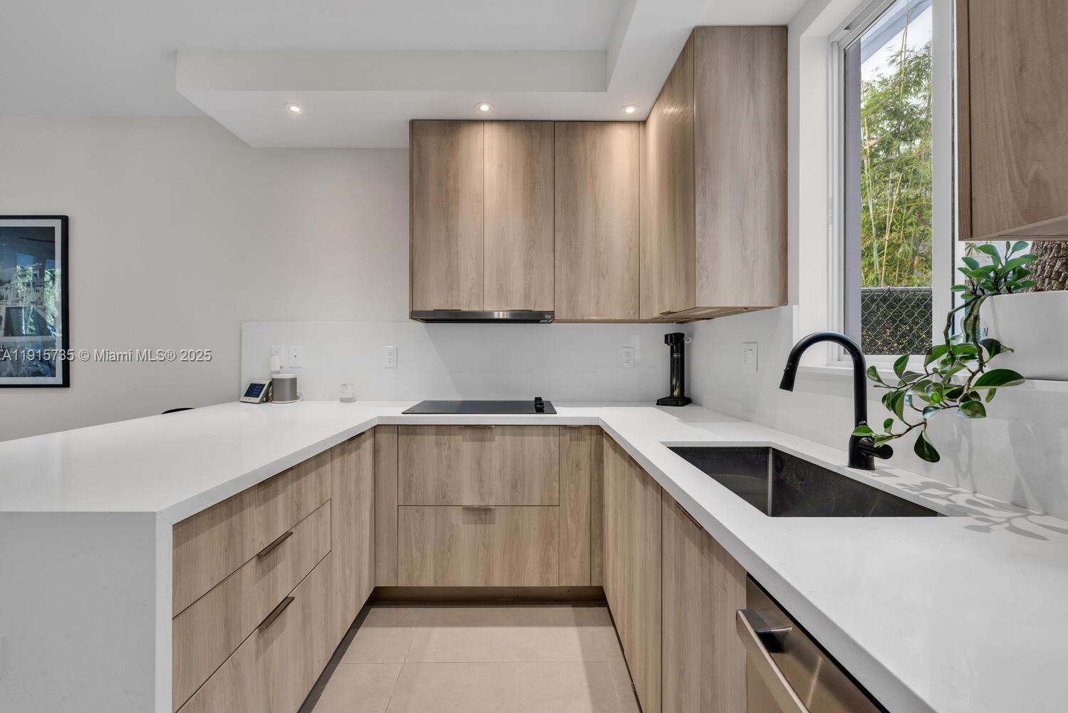 2851 Southwest 33rd Court, Unit 2851 Miami, FL 33133 - Photo 24 of 45 a kitchen with a sink and cabinets