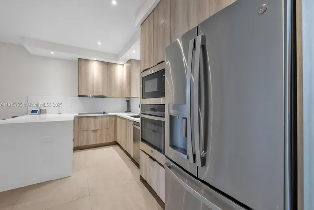 a kitchen with a refrigerator sink and microwave