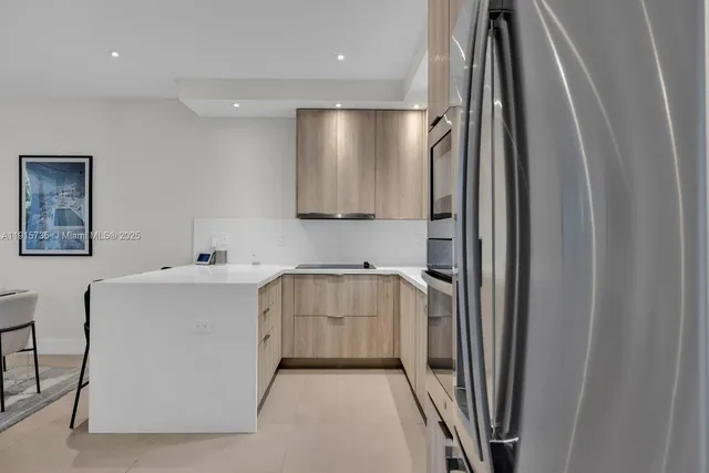 a kitchen with a refrigerator and a sink
