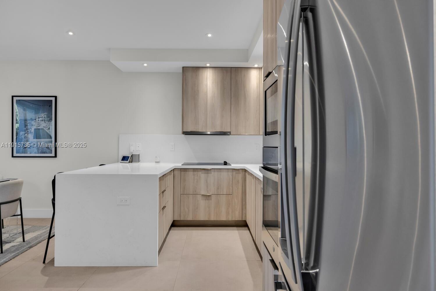 2851 Southwest 33rd Court, Unit 2851 Miami, FL 33133 - Photo 26 of 45 a kitchen with a refrigerator and a sink