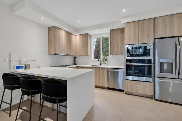 a kitchen with a sink stainless steel appliances and white cabinets
