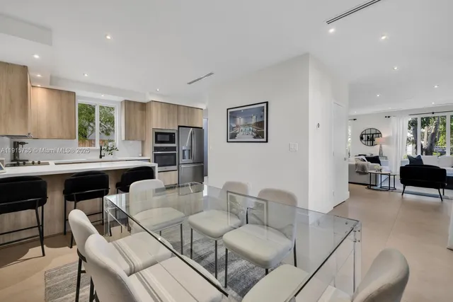 a living room with furniture and kitchen view