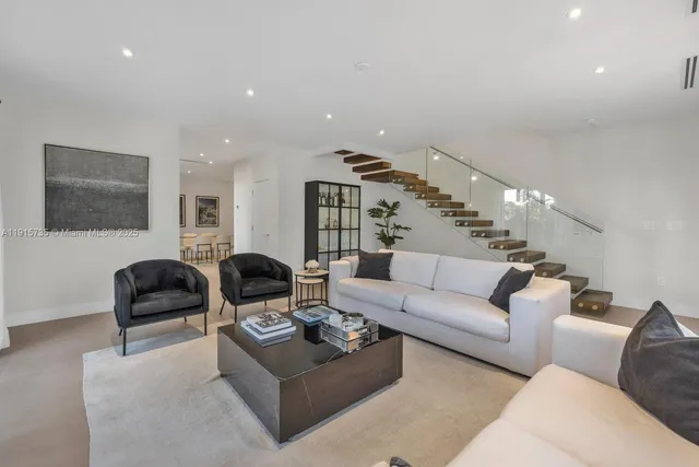 a living room with furniture and a chandelier