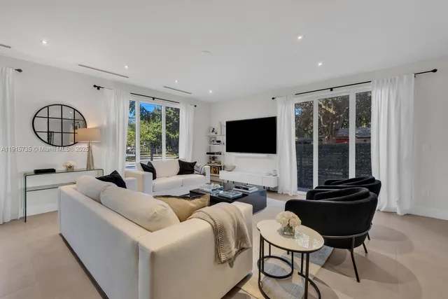 a living room with furniture fireplace and a flat screen tv