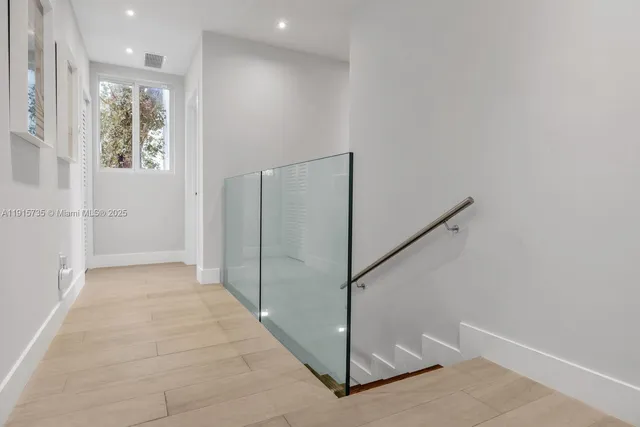 a view of an entryway with wooden floor