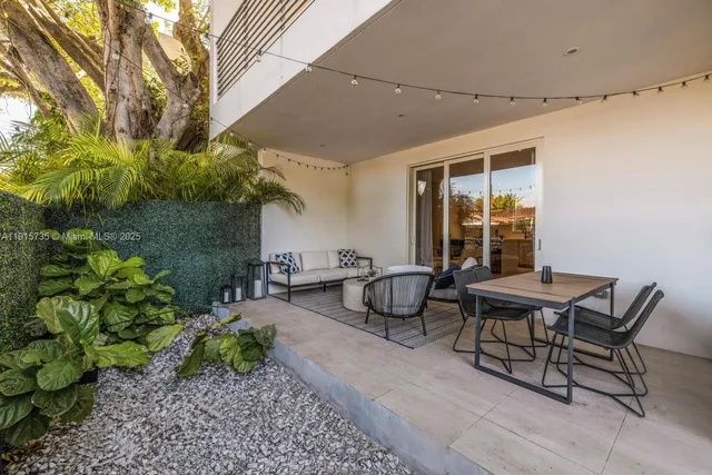 a backyard of a house with table and chairs