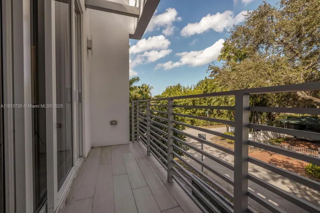 a view of a balcony with wooden floor