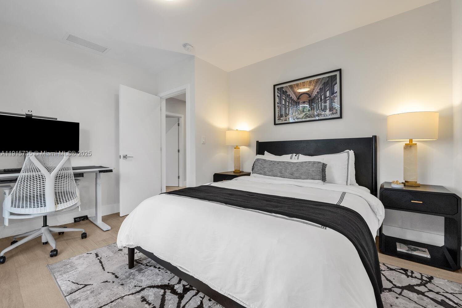 2851 Southwest 33rd Court, Unit 2851 Miami, FL 33133 - Photo 7 of 45 a bedroom with a bed and a flat screen tv