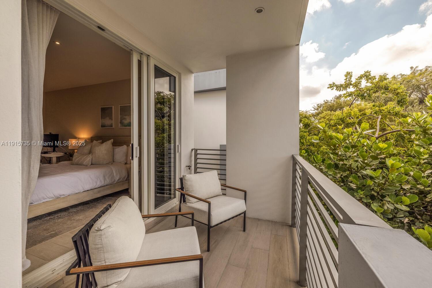 2851 Southwest 33rd Court, Unit 2851 Miami, FL 33133 - Photo 10 of 45 a hallway with a large window and wooden floor