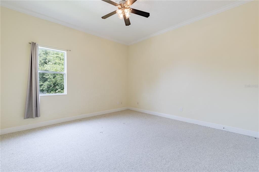 2718 Knightsbridge Road Clermont, FL 34711 - Photo 18 of 72 an empty room with a window and a fan