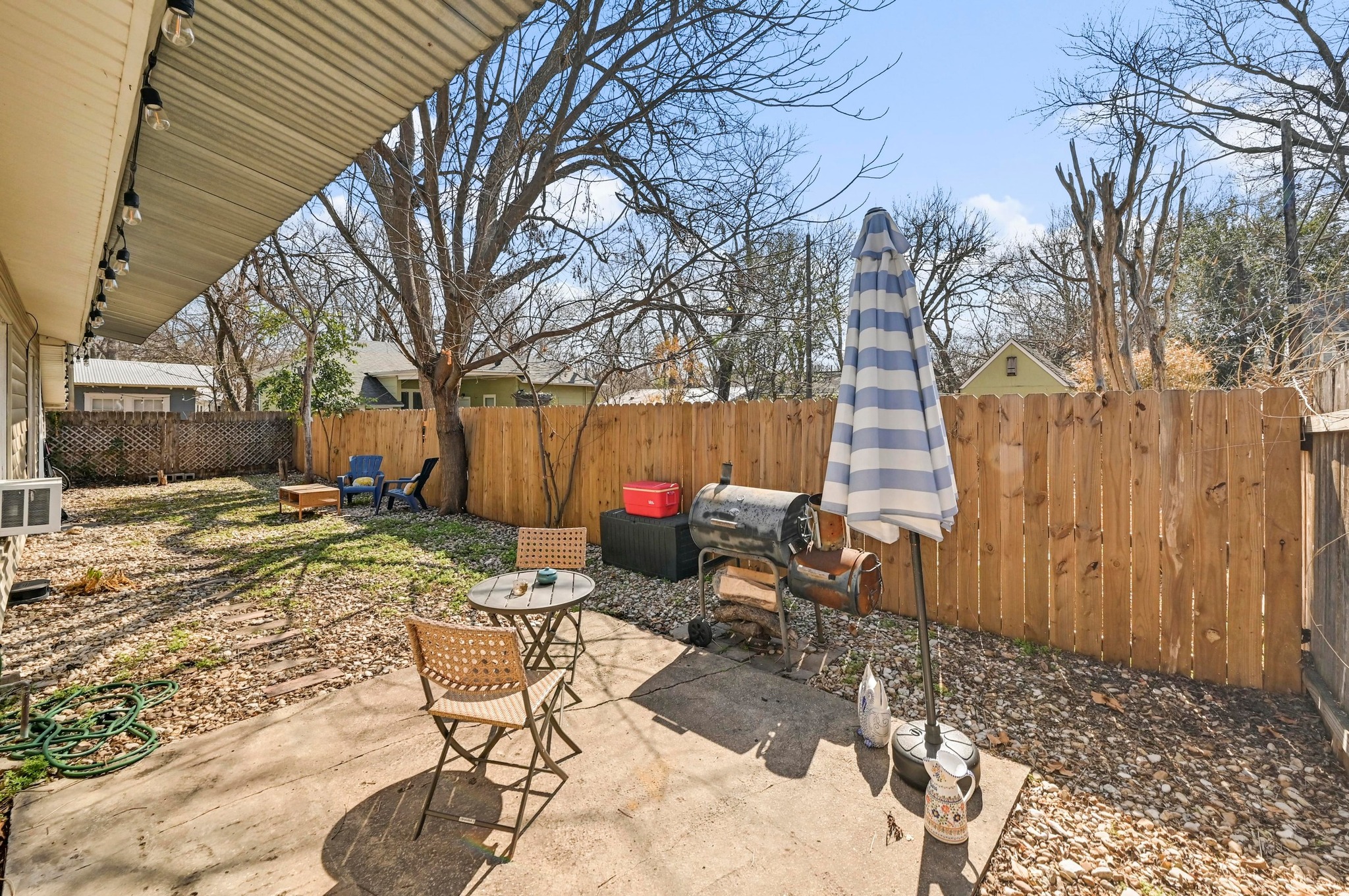 4530 Avenue D, Unit B Austin, TX 78751 - Photo 22 of 29 a view of a backyard with table and chairs and wooden fence