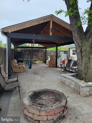 a view of patio with a table and chairs under an umbrella