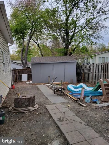 a view of backyard with swimming pool and furniture