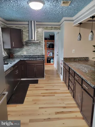 a kitchen with stainless steel appliances granite countertop a stove and a sink