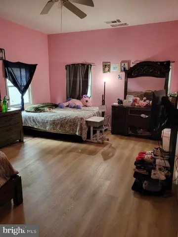 a bedroom with bed and window