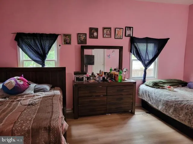 a bed room with a bed and a painting on the wall