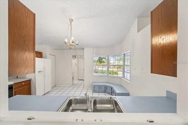 a kitchen with stainless steel appliances granite countertop a stove sink and cabinets