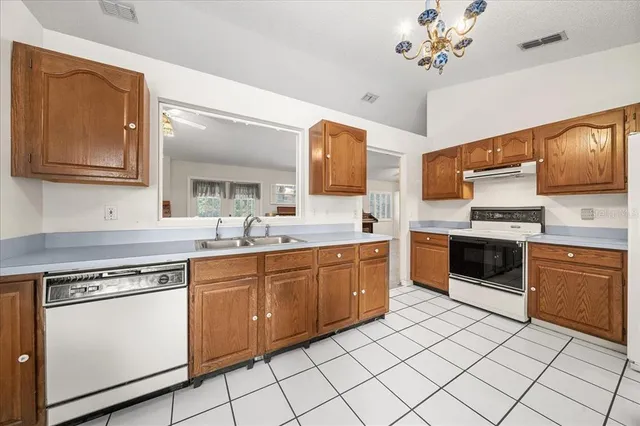 a large kitchen with cabinets and stainless steel appliances