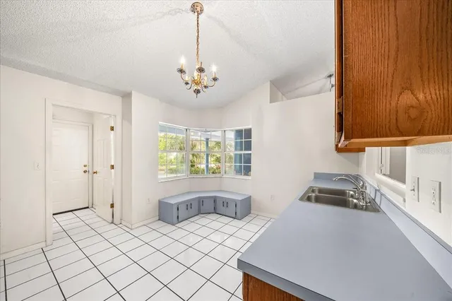 a kitchen with a sink appliances and cabinets