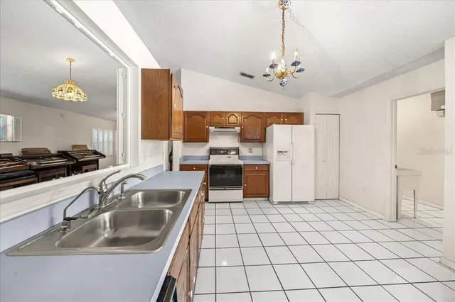 a kitchen with a stove sink and cabinets